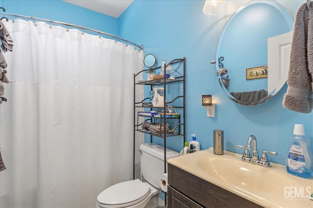 Undisclosed Address Tehachapi, CA 93561 - Photo 17 of 29 a bathroom with a sink vanity mirror and toilet