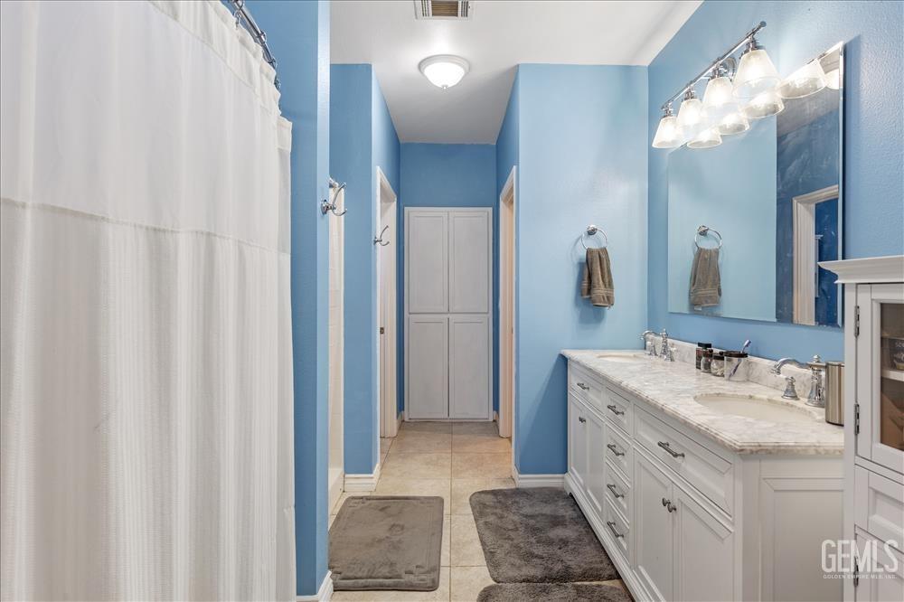 Undisclosed Address Tehachapi, CA 93561 - Photo 20 of 29 a bathroom with a double vanity sink mirror and shower