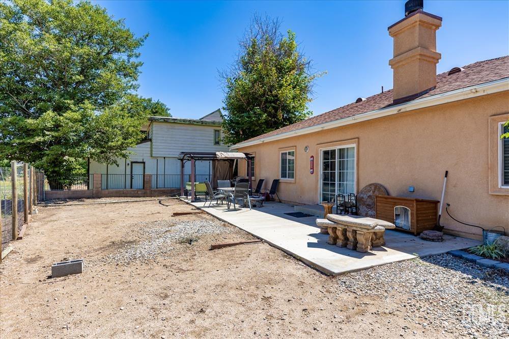 Undisclosed Address Tehachapi, CA 93561 - Photo 21 of 29 a view of a backyard with a patio and outdoor seating