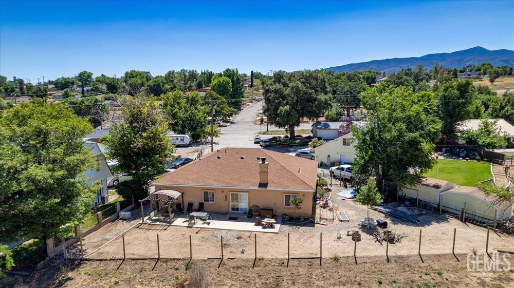 Undisclosed Address Tehachapi, CA 93561 - Photo 26 of 29 a view of a patio with couches table and chairs under an umbrella