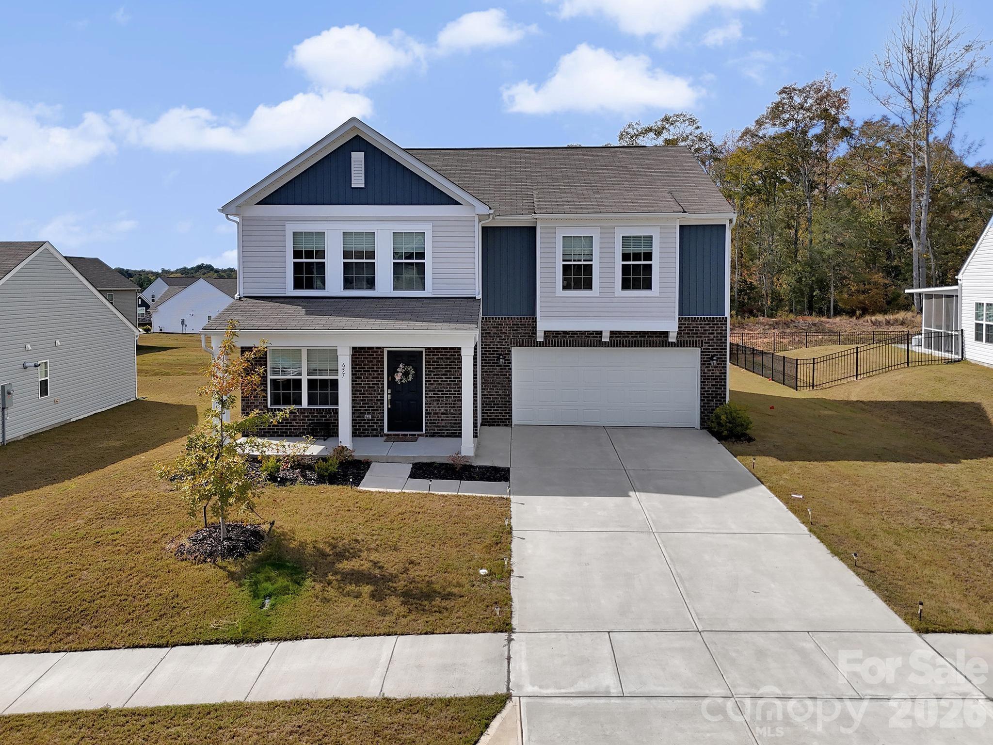 657 Mile Crk Road Edgemoor, SC 29712 - Photo 2 of 40 a front view of a house with garden