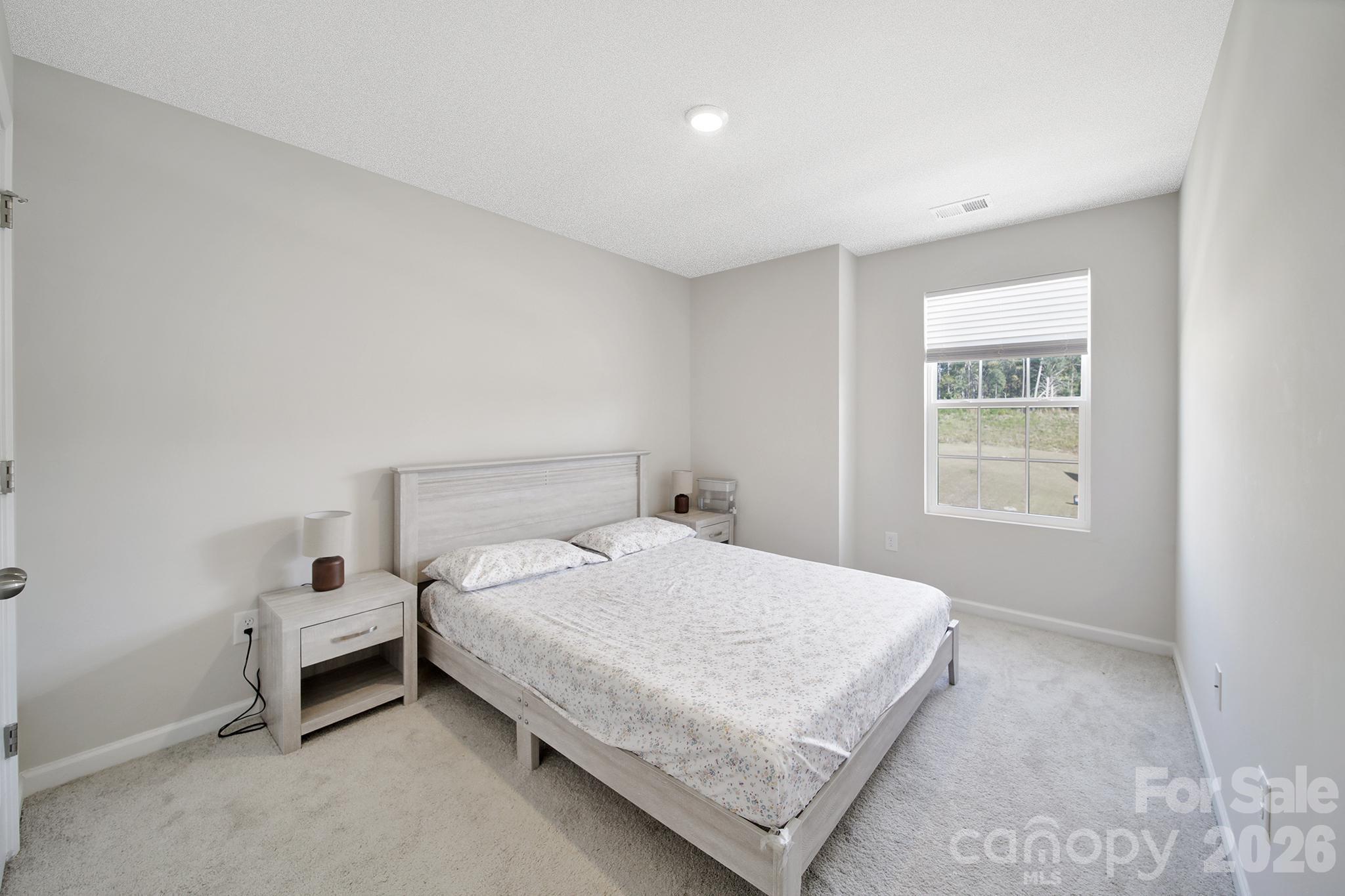657 Mile Crk Road Edgemoor, SC 29712 - Photo 32 of 40 a bedroom with a bed and window
