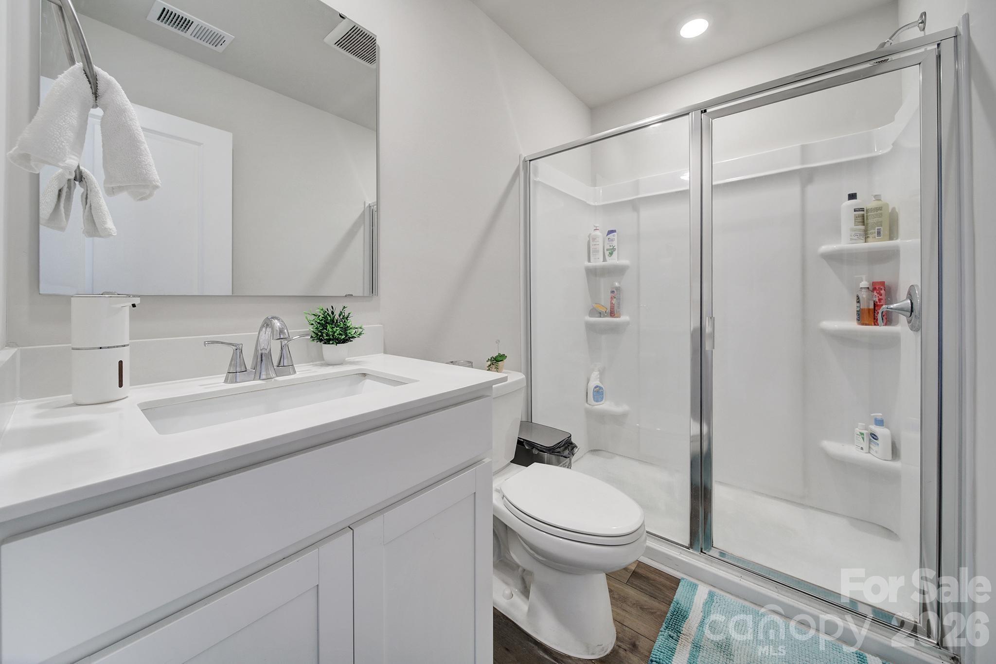657 Mile Crk Road Edgemoor, SC 29712 - Photo 35 of 40 a bathroom with a granite countertop sink a toilet and shower