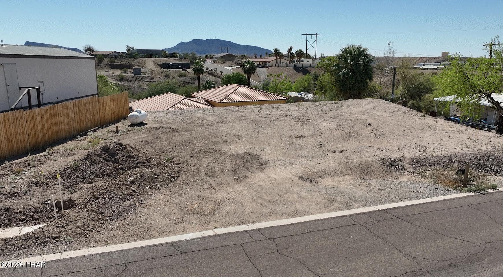 31846 Treasure Road Parker, AZ 85344 - Photo 4 of 13 a view of a dry yard with wooden fence