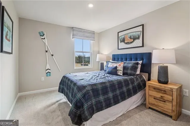 a bedroom with a bed and painting on the wall