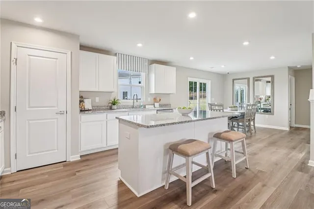 a kitchen with sink stove and cabinets
