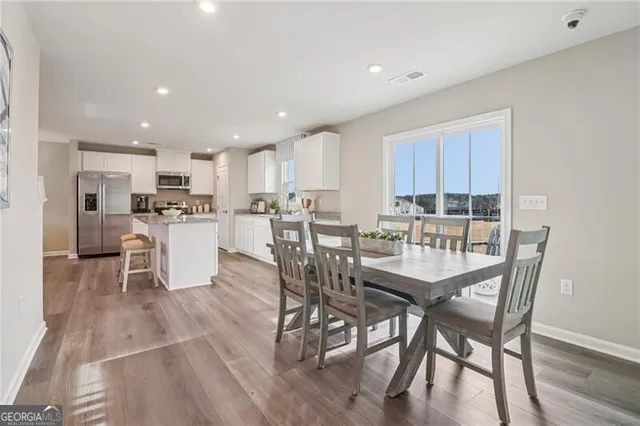 a kitchen with a refrigerator and a potted plant