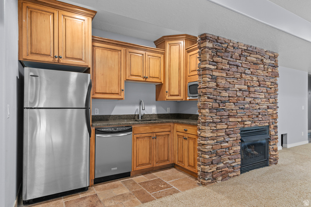 1501 West Elk Circle Mapleton, UT 84664 - Photo 31 of 39 Compact kitchen area featuring wood cabinetry, stainless steel appliances, and a built-in microwave