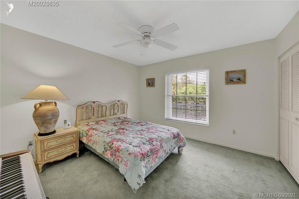 1860 Southwest Palm City Road, Unit 201 Stuart, FL 34994 - Photo 29 of 45 a bedroom with a bed and window