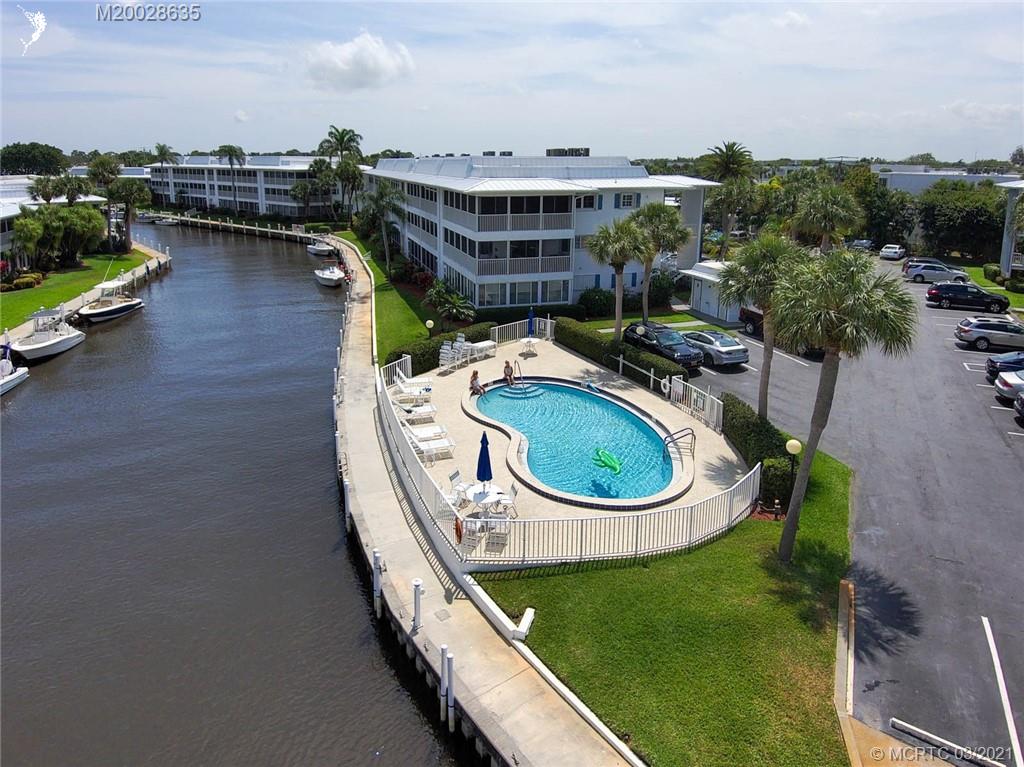 1860 Southwest Palm City Road, Unit 201 Stuart, FL 34994 - Photo 35 of 45 an aerial view of a house with swimming pool garden and lake view