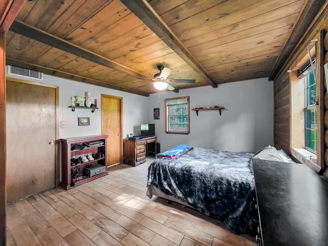 a bedroom with a bed and a tv