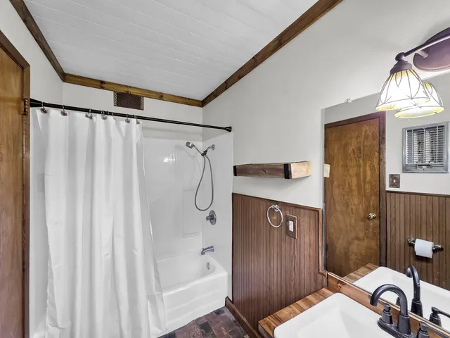 a bathroom with a sink a mirror and a shower