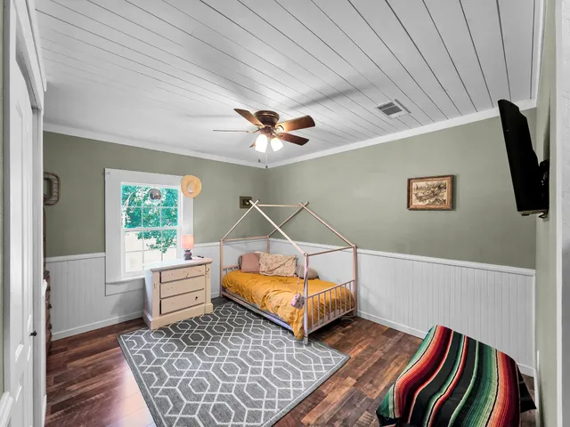 a living room with a bed and a chandelier