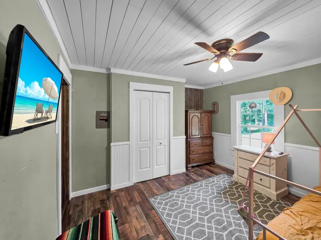 a bedroom with furniture window and a ceiling fan