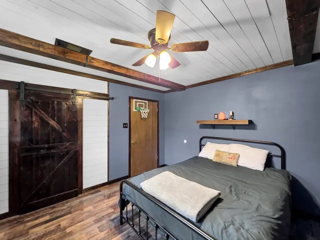 a bedroom with a bed and a chandelier