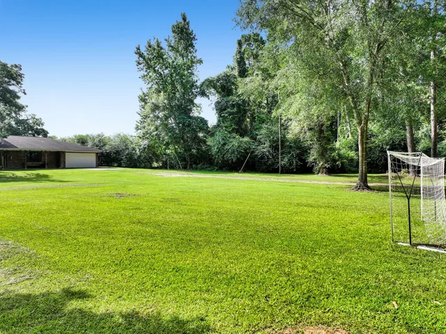 a view of a garden with a house