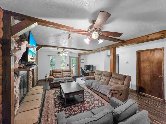 a living room with furniture ceiling fan and a rug