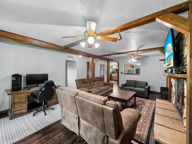 a livingroom with furniture and a flat screen tv
