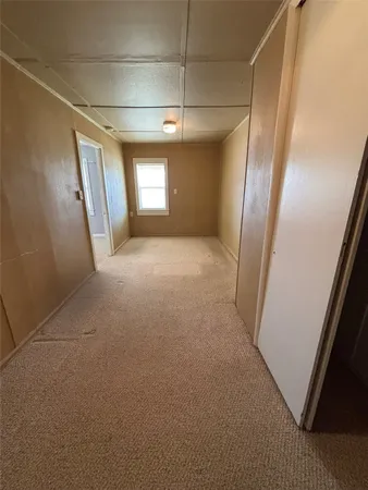 a view of a room with furniture and a window