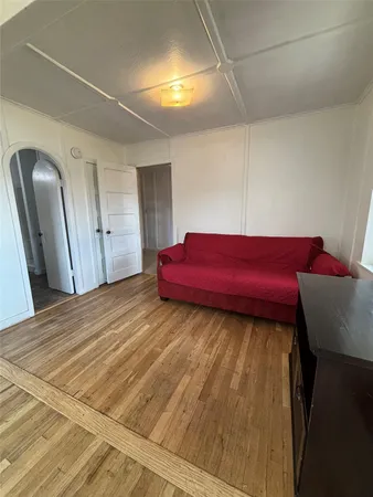 a living room with a bed and a window
