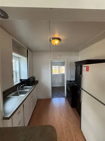 a view of a kitchen from the hallway