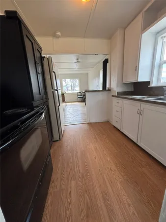 a kitchen with a refrigerator and a stove