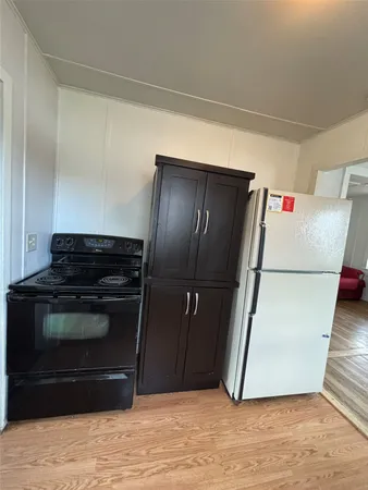 a kitchen with granite countertop a sink and a stove