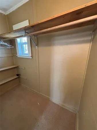 a view of empty room with windows and cabinet