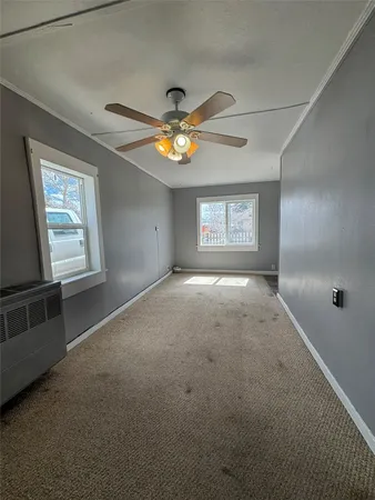 a kitchen with stainless steel appliances granite countertop a refrigerator a sink a stove and white cabinets