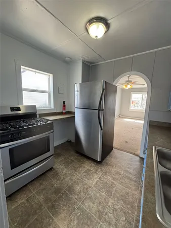 a kitchen with stainless steel appliances granite countertop a sink stove and cabinets