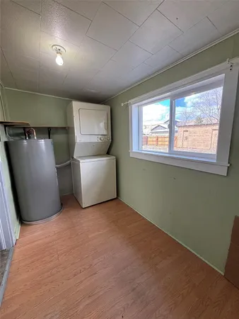 a kitchen with granite countertop a sink a stove and cabinets