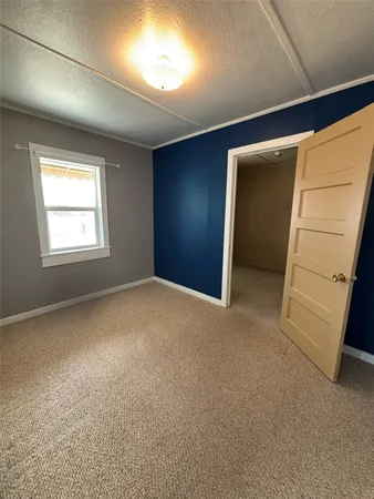 a view of an empty room with a closet