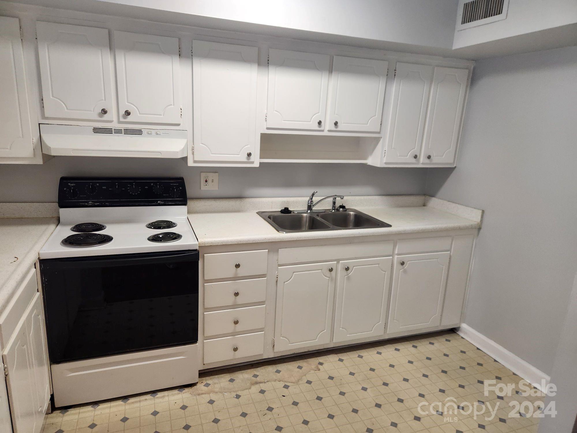 910 McAlway Road, Unit C Charlotte, NC 28211 - Photo 2 of 10 a kitchen with a sink stove and cabinets