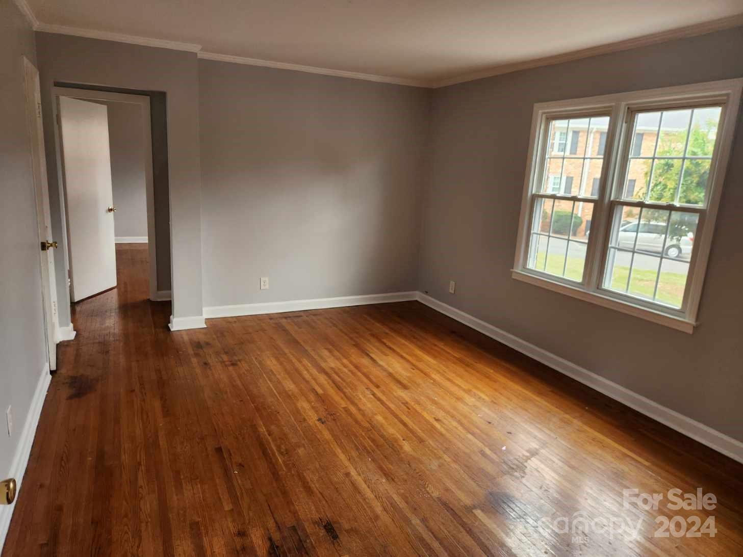 910 McAlway Road, Unit C Charlotte, NC 28211 - Photo 5 of 10 wooden floor in an empty room with a window