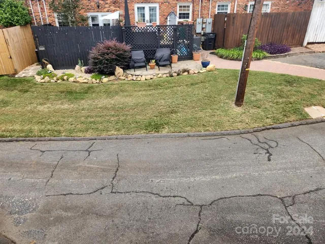 a view of a backyard with plants and outdoor seating