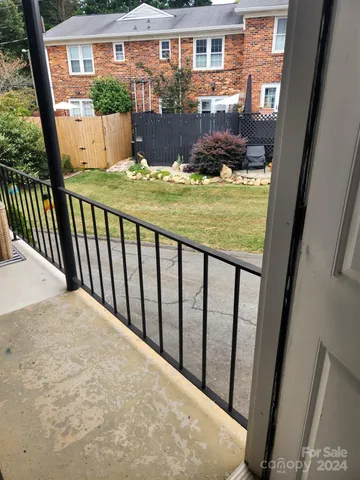 a view of balcony with floor to ceiling window and wooden fence