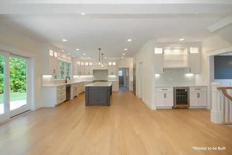 a large white kitchen with a large window