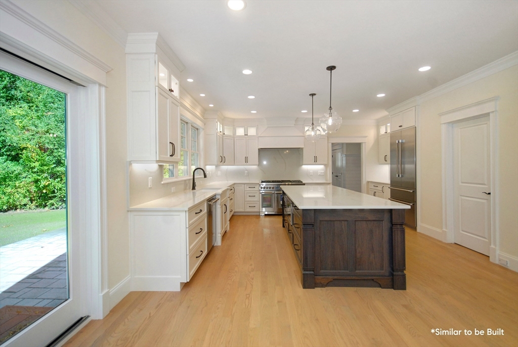 54 Maple Street Concord, MA 01742 - Photo 6 of 27 a large kitchen with kitchen island a sink stainless steel appliances and cabinets
