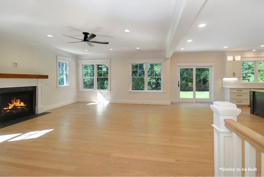 54 Maple Street Concord, MA 01742 - Photo 8 of 27 a view of an empty room with a fireplace and a window