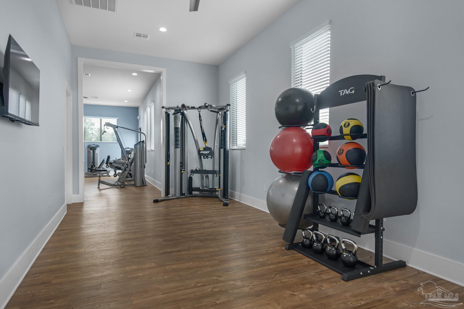 4739 Eider Road Pace, FL 32571 - Photo 26 of 30 a gym hall with hardwood floor