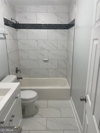 a bathroom with a bathtub a toilet and a shower