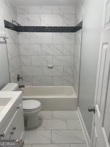 a bathroom with a bathtub a toilet and a shower