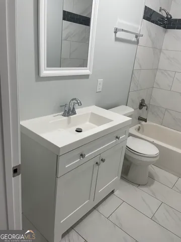 a bathroom with a sink toilet and mirror