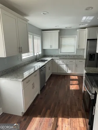 a kitchen with a sink stove and cabinets