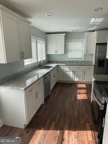 a kitchen with a sink stove and cabinets