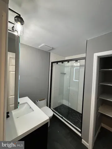 a bathroom with a sink a mirror and a shower