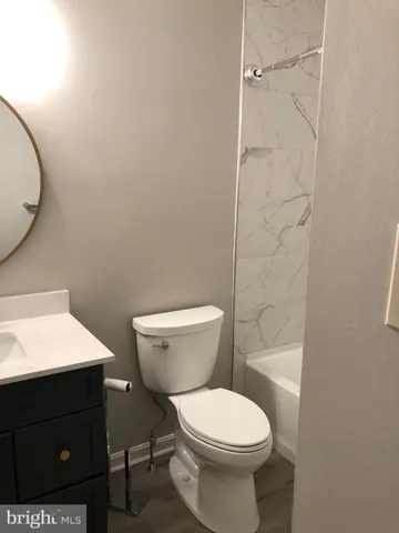 a bathroom with a toilet a sink and vanity