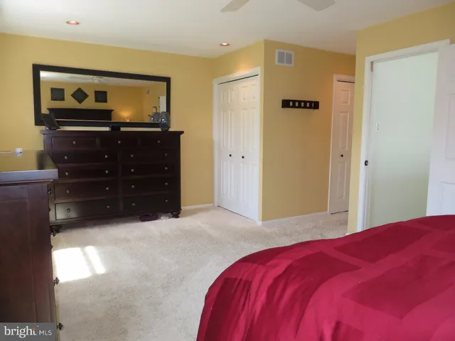 a bedroom with a bed and a television