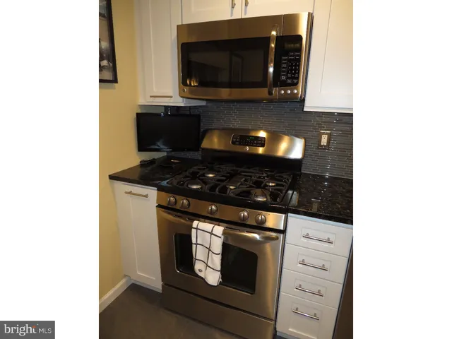 a kitchen with a stove and a microwave