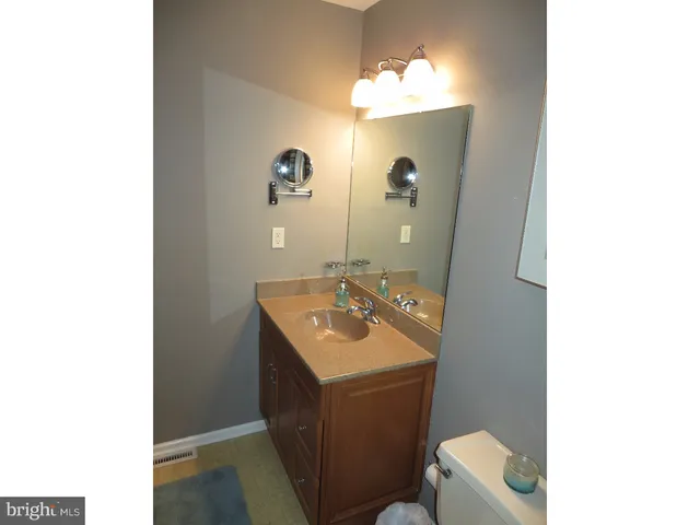 a bathroom with a sink toilet and mirror